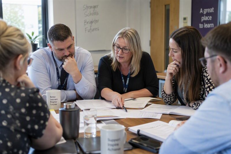 School leaders around a table planning a multi-academy trust payments rollout
