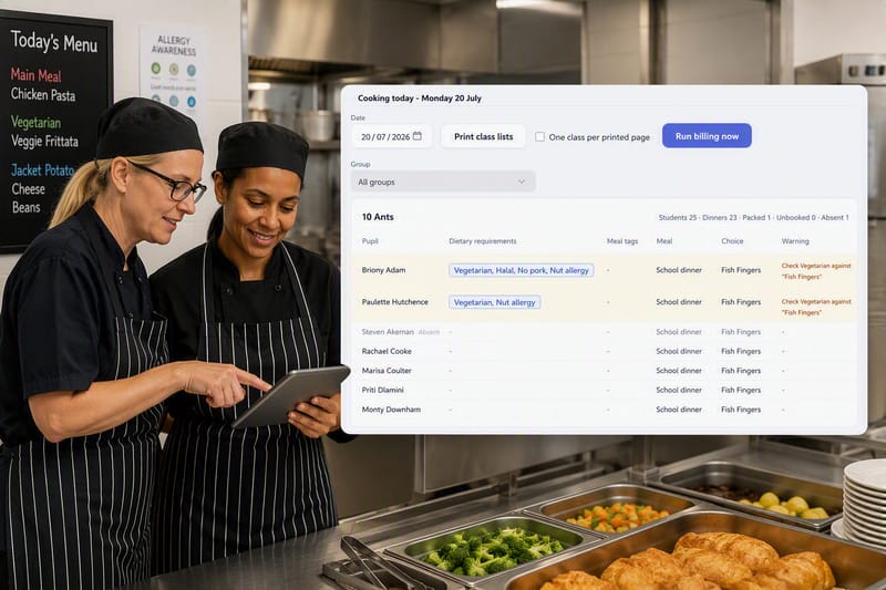 Catering staff checking dietary requirements on a tablet in a school kitchen